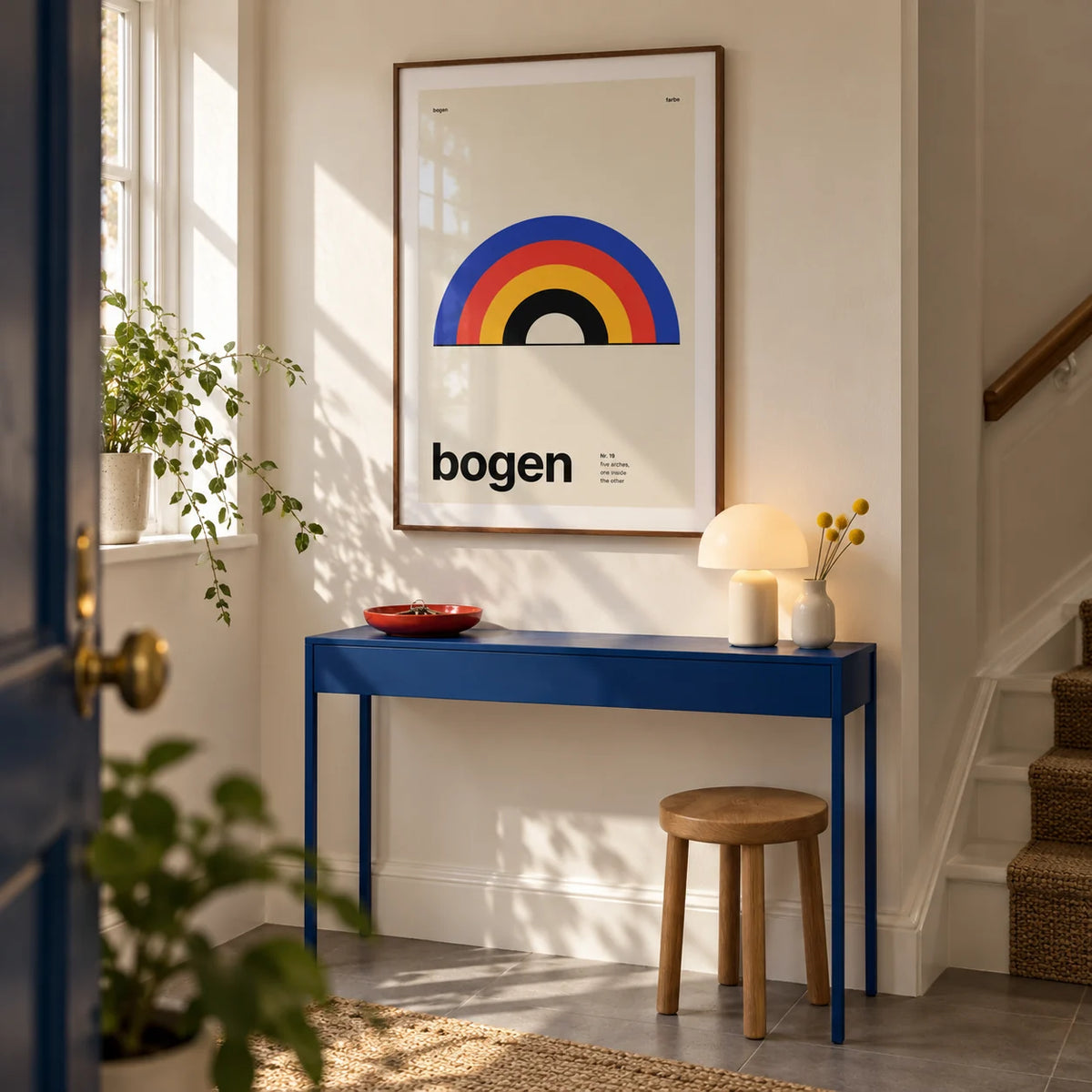 Arch Print, framed on the wall of a bright entrance hallway in a British maisonette with a warm white wall and plain grey floor tiles