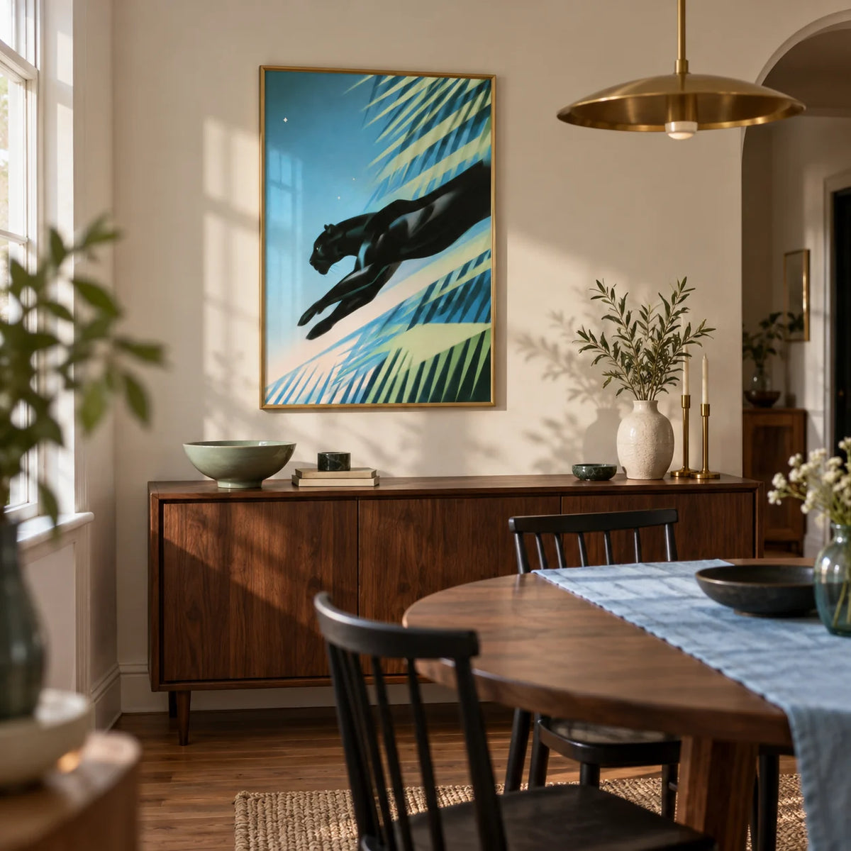 Art Deco Black Panther Print, framed on the wall of a compact dining room in a renovated UK terrace with a warm cream wall and a curved doorway