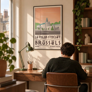 Art Deco Brussels Print, framed on the wall of a compact home study for an architecture enthusiast in a UK city flat with a warm cream wall and built-in walnut shelves holding a few plain bound books