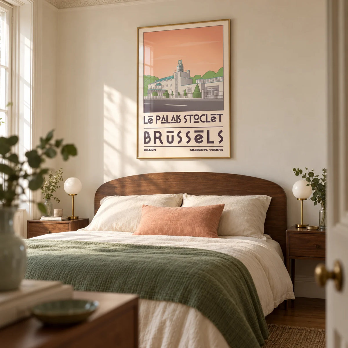 Art Deco Brussels Print, framed on the wall of a restful main bedroom in a period UK flat with cream walls and a curved walnut headboard