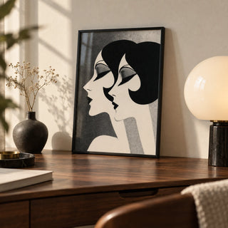 Art Deco Female Profiles Print, a small A4 framed print leaning on a walnut writing desk