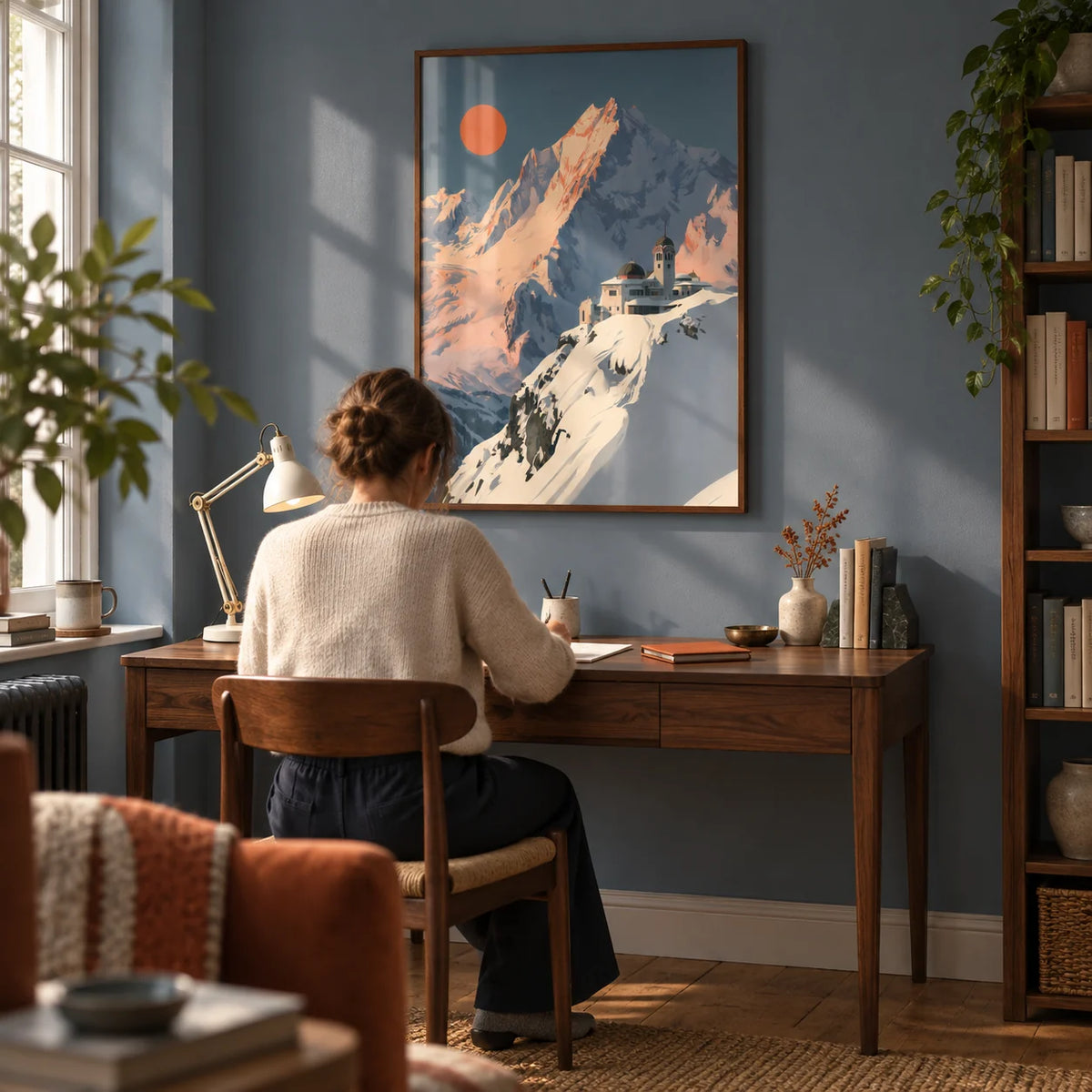 Art Deco Mountain Poster, framed on the wall of a quiet home study in a UK flat with a muted slate blue wall and warm oak floorboards