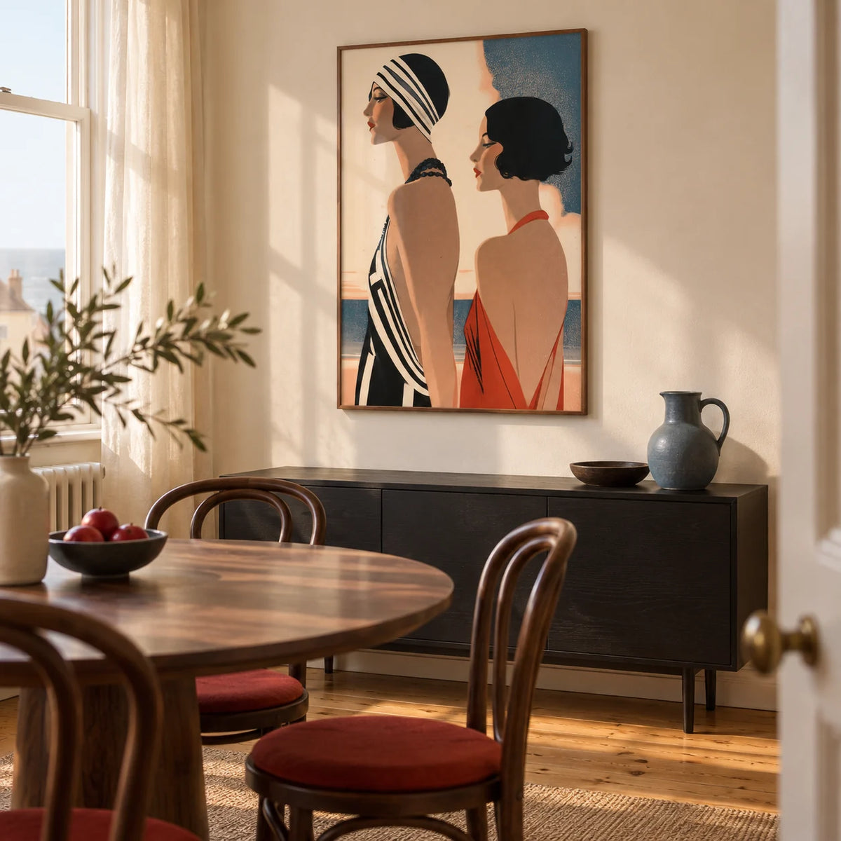 Art Deco Riviera Fashion Print, framed on the wall of a warm dining room in a British seaside terrace with pale cream walls and honey toned floorboards