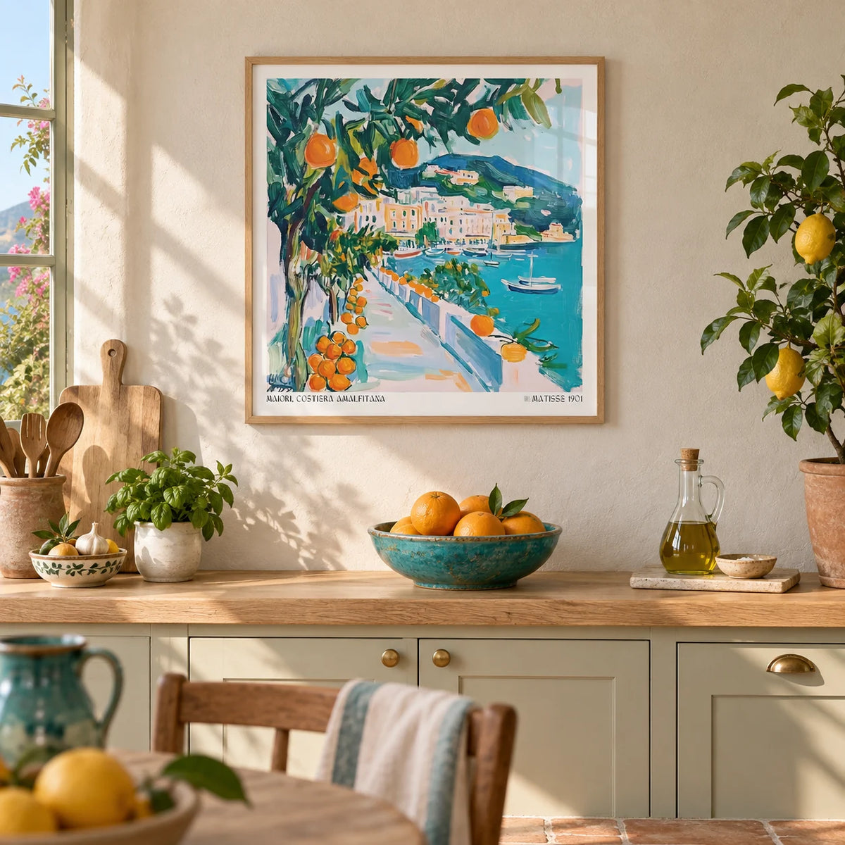 Art Prints of Italy, framed on the wall of a sunny Mediterranean-style kitchen with a warm white limewashed wall and a pale terracotta floor