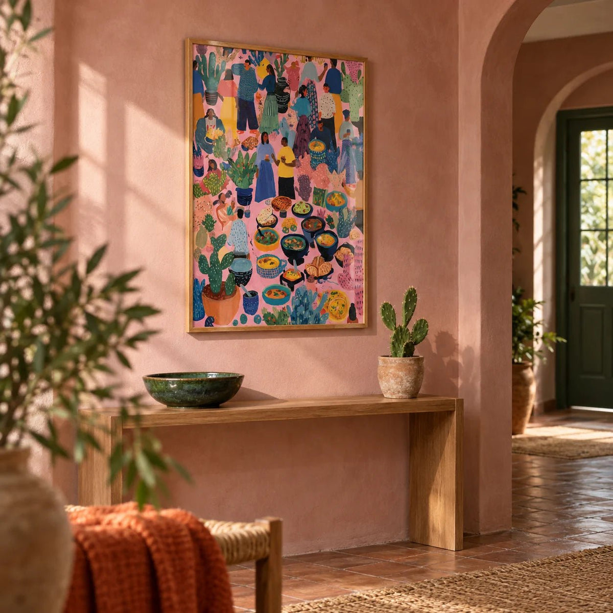 Artwork from Mexico, framed on the wall of a warm hallway with a plastered arch