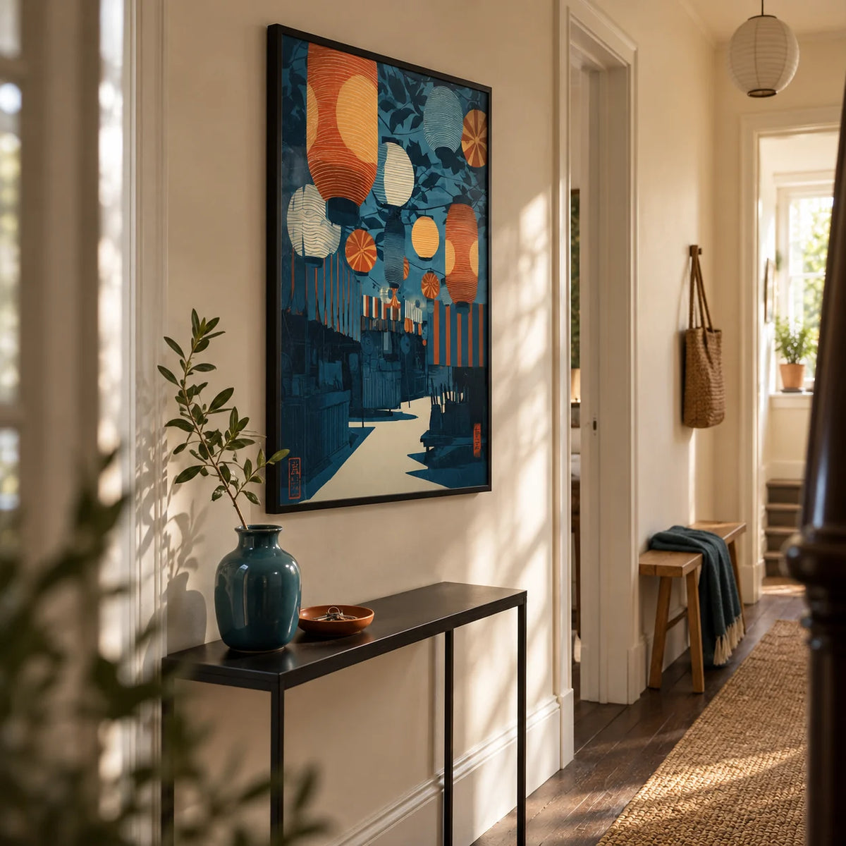 Asian Festival Art Print, framed on the wall of a welcoming narrow hallway in a renovated UK terrace with pale cream walls and dark wood flooring
