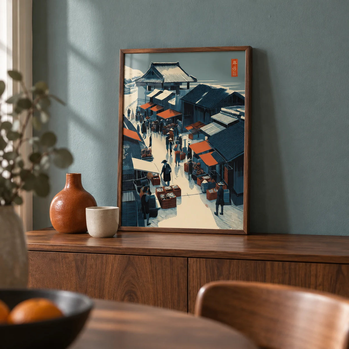 Asian Market Wall Art, a small A4 framed print leaning on a walnut sideboard in a dining room