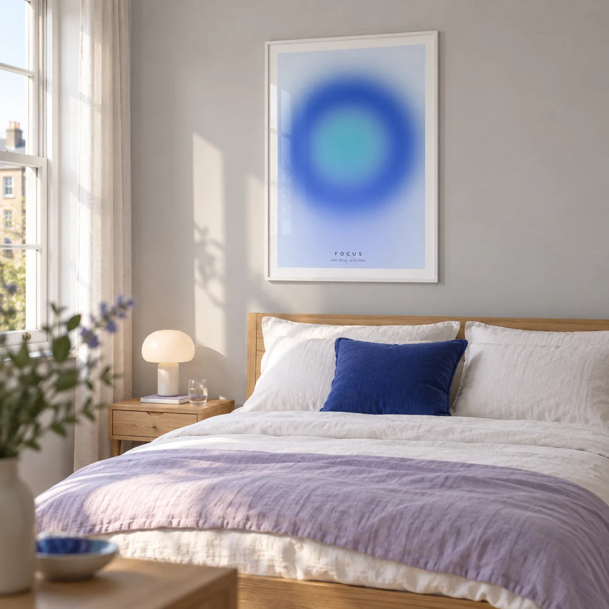 Aura Poster, framed on the wall of a calm contemporary bedroom in a UK flat with a pale grey wall