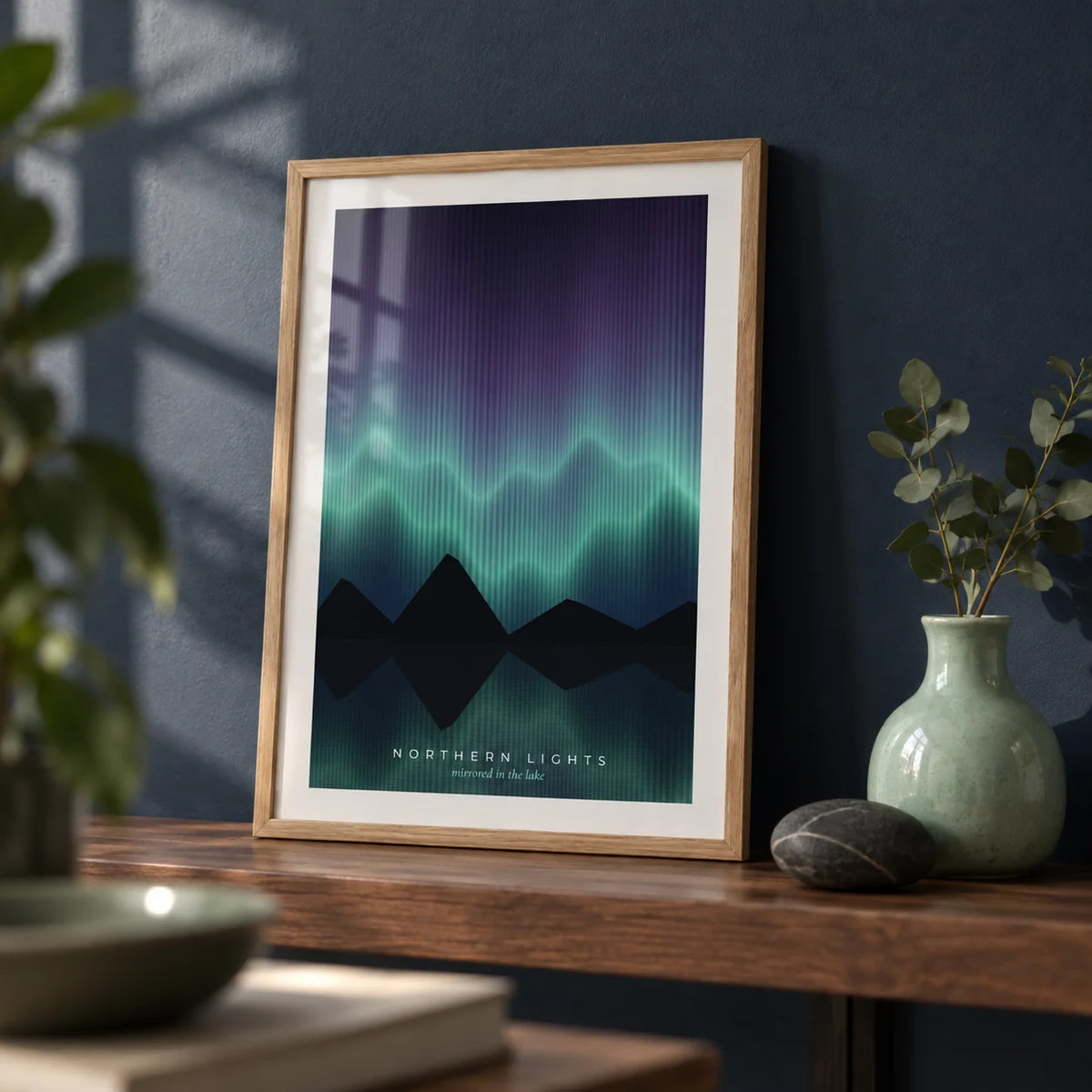 Aurora Borealis Print, a small A4 framed print leaning on a walnut shelf in a living room
