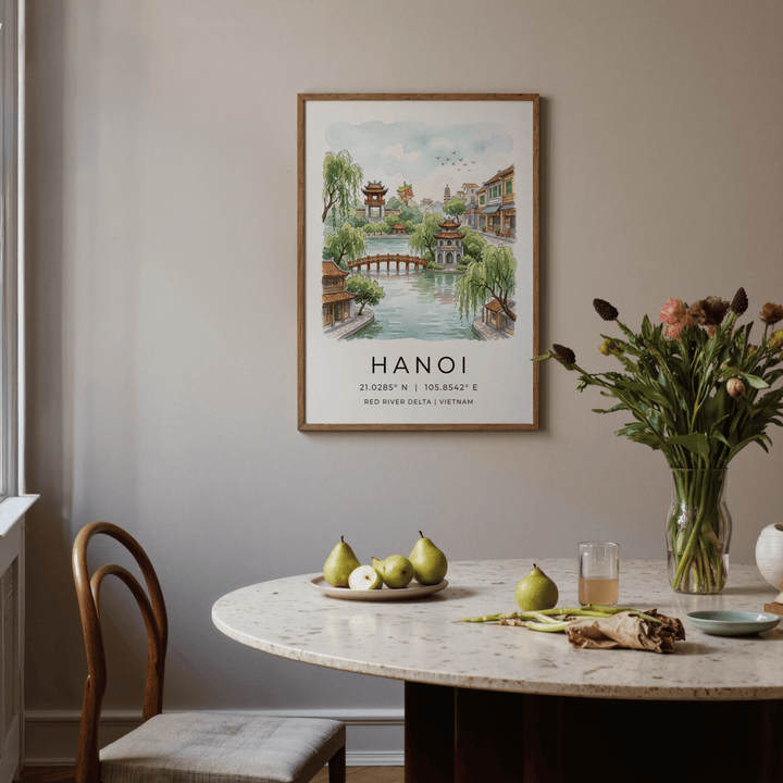 Hanoi Landscape wall art of a red river scene with green trees on a grey dining room wall with a table and fruit plate