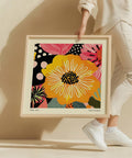 Bold yellow flower wall art with intricate white details.