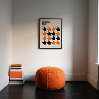 Bold orange and black shapes form a structured artwork for office interiors.