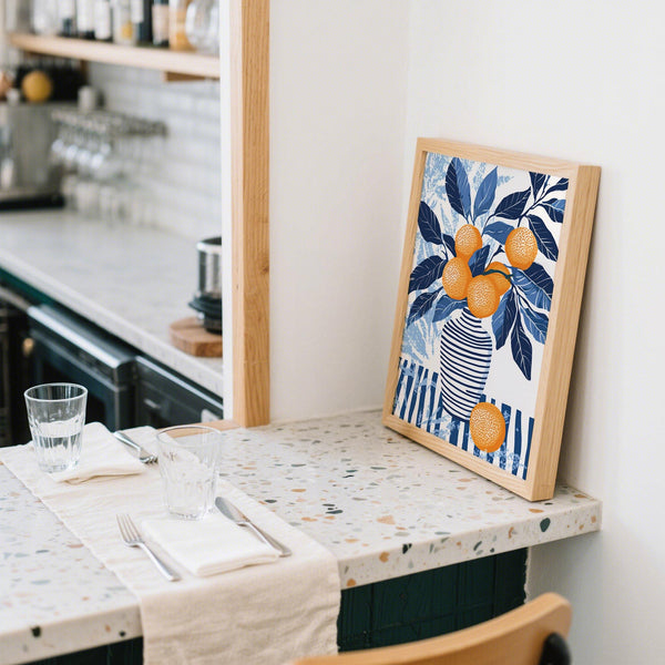 Citrus-themed orange blue wall art hanging on blue accent wall.