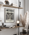 Typographic city poster featuring Amsterdam title above a symmetrical museum passage photo