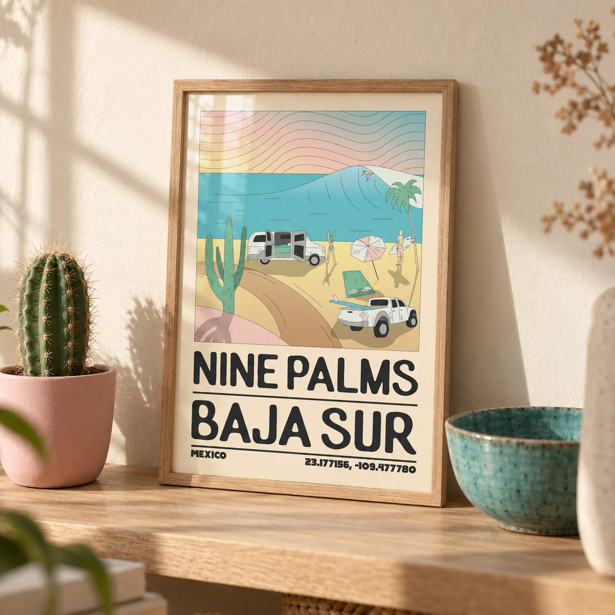 Baja Sur Wall Art, a small A4 framed print leaning on a pale oak shelf in a living room