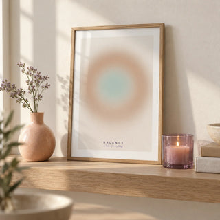 Balance Print, a small A4 framed print leaning on a pale oak shelf in a living room