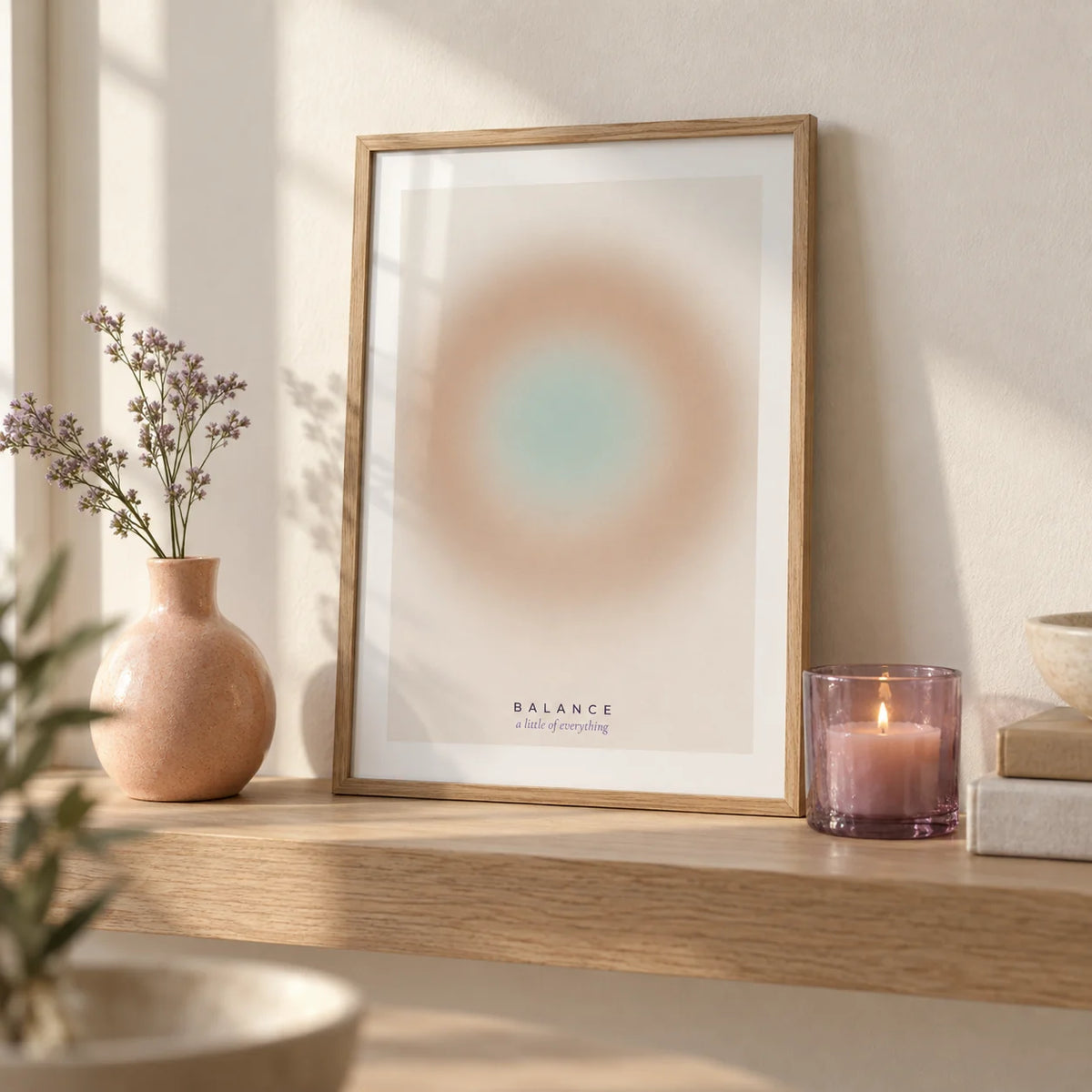 Balance Print, a small A4 framed print leaning on a pale oak shelf in a living room
