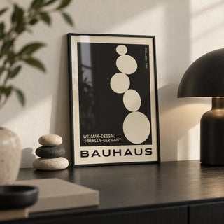 Balancing Stones Wall Art, a small A4 framed print leaning on a black desk