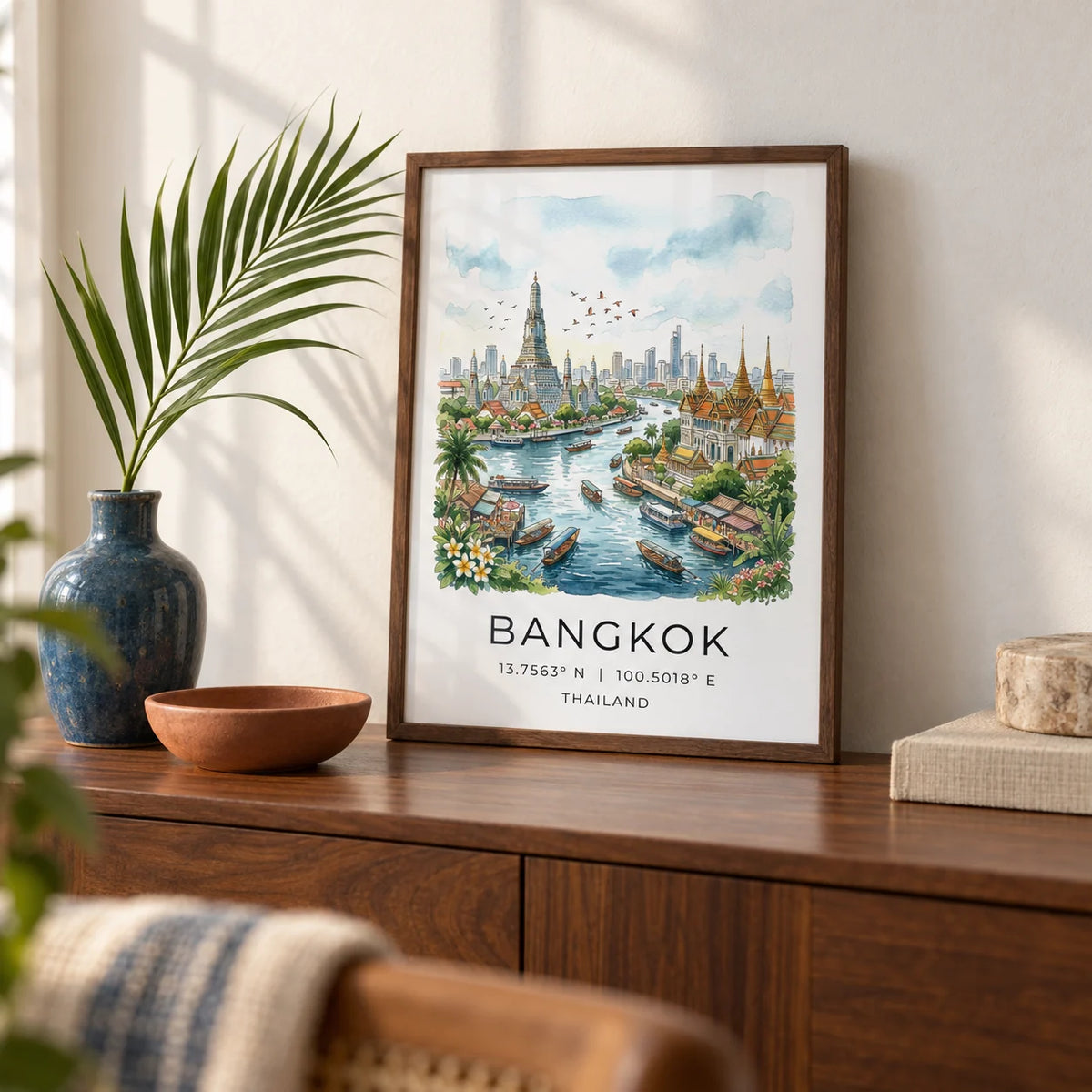Bangkok City Art Print, a small A4 framed print leaning on a walnut sideboard in a living room