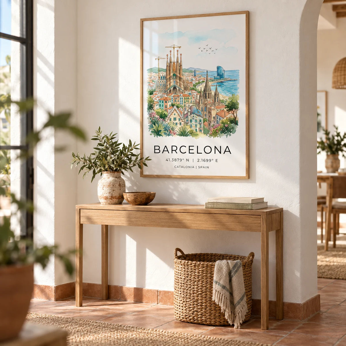 Barcelona Watercolor Poster, framed on the wall of a bright hallway with a white plaster wall and terracotta floor
