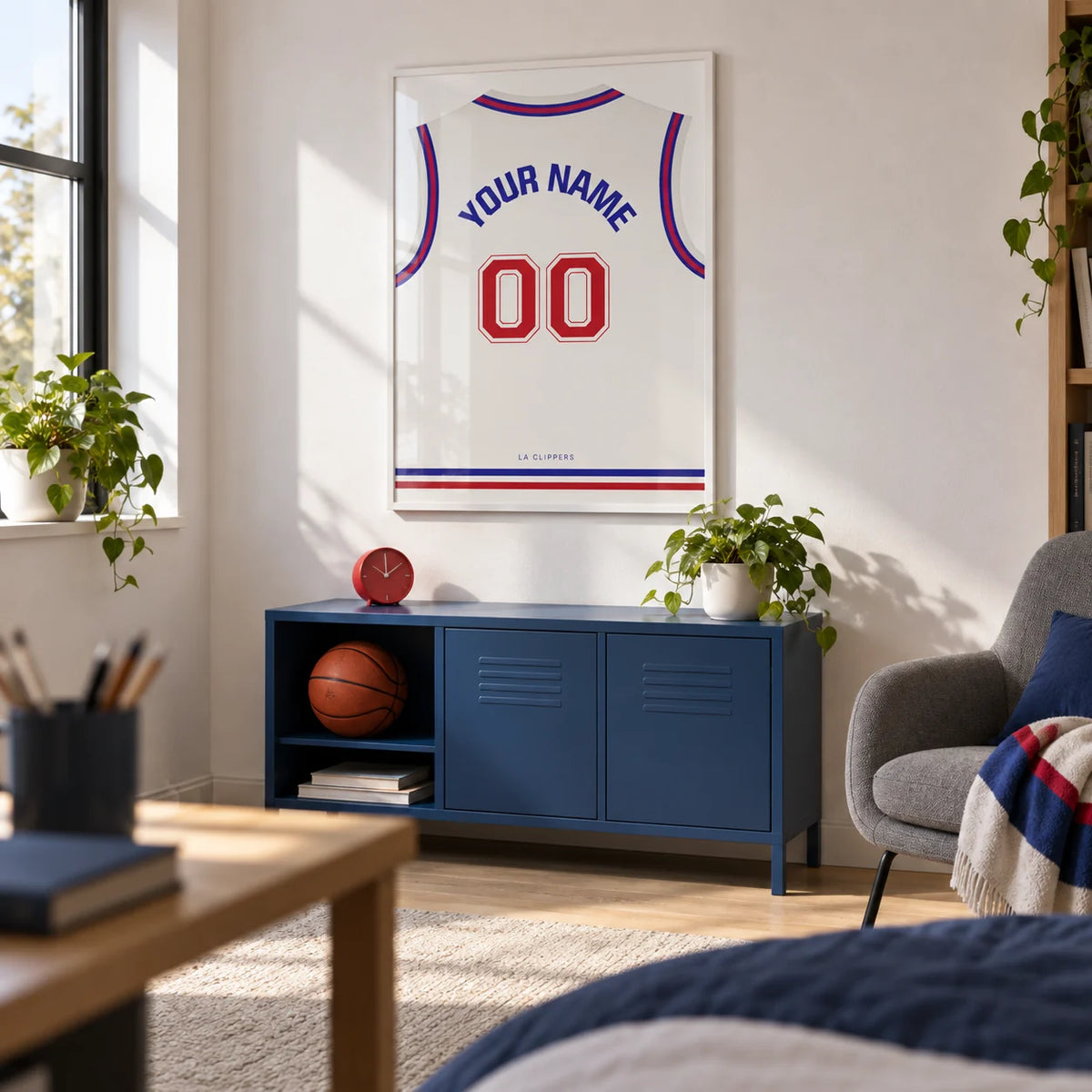 Basketball Jersey Poster in Plain White with Red Number, framed on the wall of a basketball fan's university room for ages 18-21 with a white wall and practical pale wood furniture in a home office