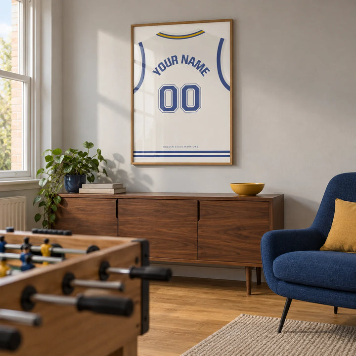 Basketball Jersey Poster in White with Blue Number, framed on the wall of a basketball fan's games snug in a UK terraced house with a pale grey wall and oak floor in a living room