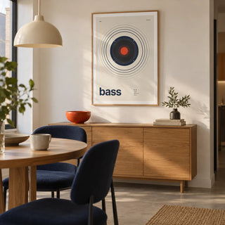 Bass Poster, framed on the wall of a modern dining nook in a compact UK flat with a warm white wall and a plain concrete floor