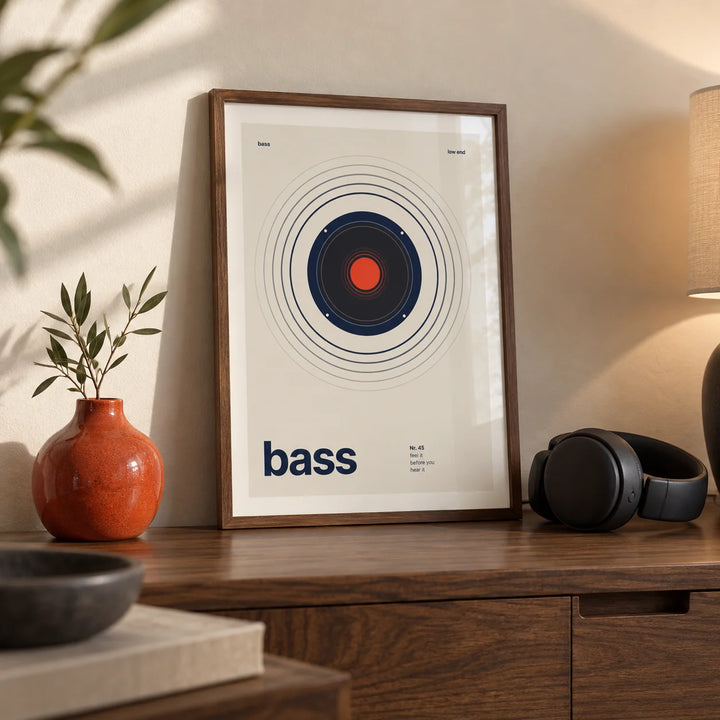 Bass Poster, a small A4 framed print leaning on a walnut side table in a hallway