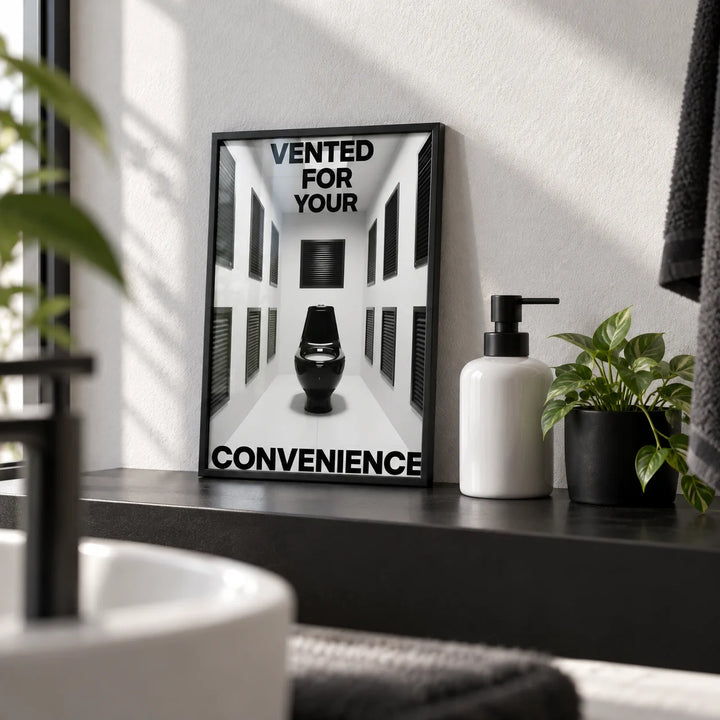Bathroom Funny Print, a small A4 framed print leaning on a black bathroom shelf