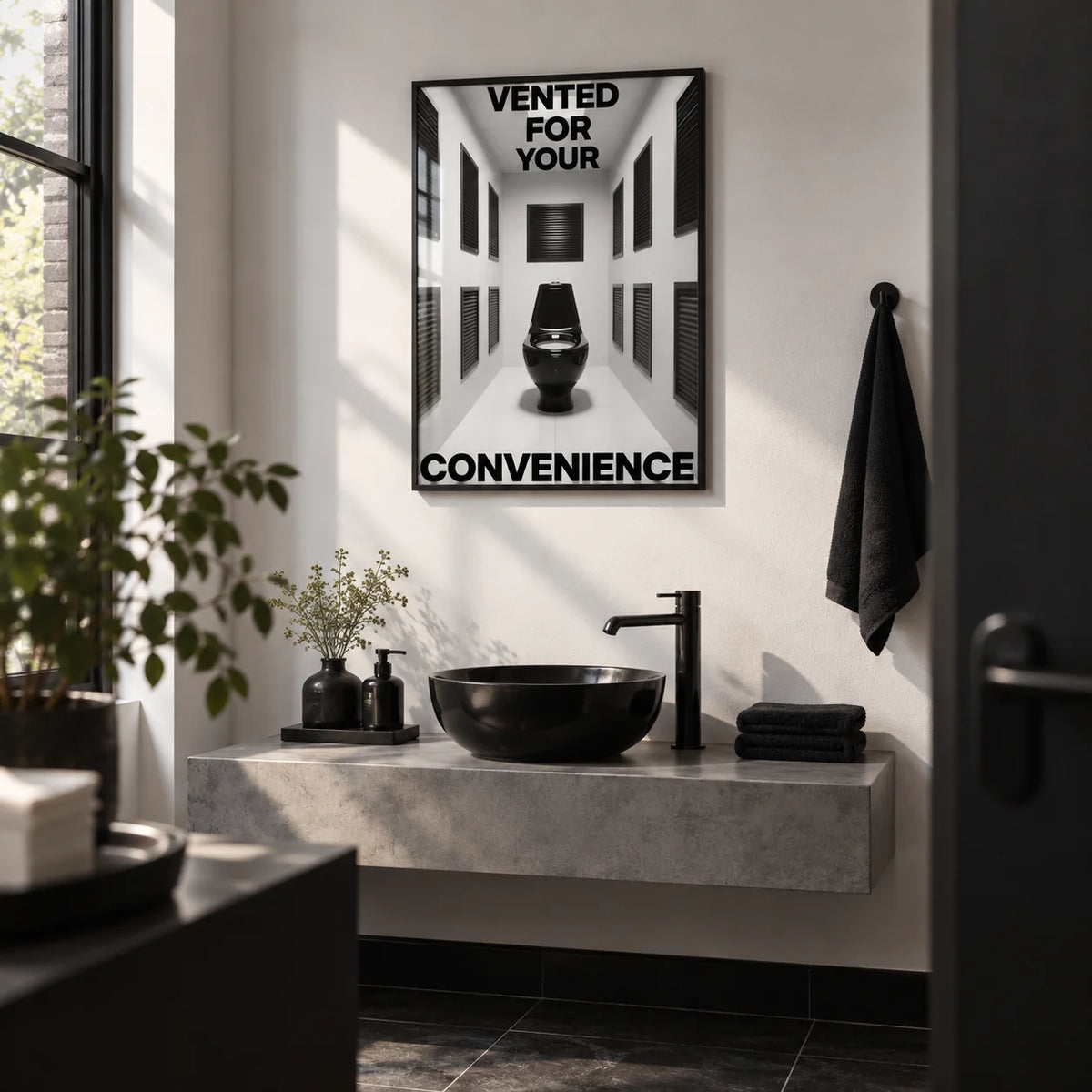 Bathroom Funny Print, framed on the wall of a small modern bar or restaurant washroom with a plain white wall and a black floor