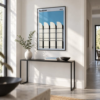 Bauhaus Architecture Art Poster, framed on the wall of a crisp white hallway with a pale grey floor