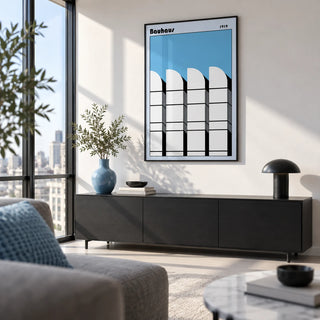 Bauhaus Architecture Art Poster, framed on the wall of a design-led city flat with a white wall and floor-to-ceiling windows in a living room