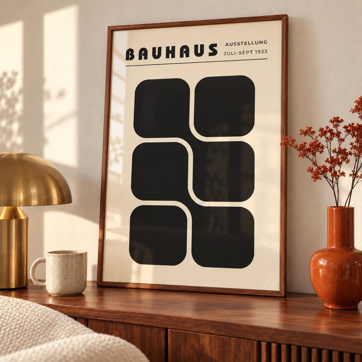 Bauhaus Art Black and White, an A3 framed print leaning on a walnut sideboard in a living room