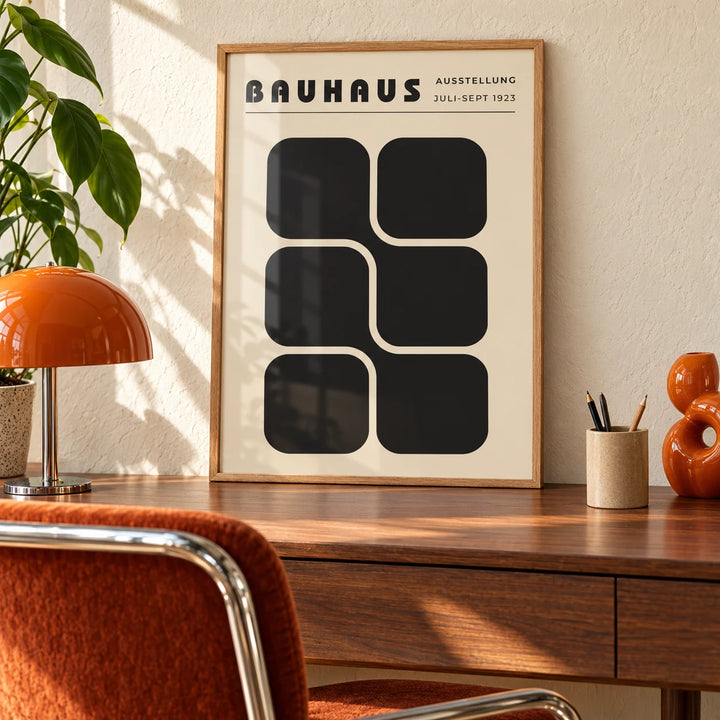 Bauhaus Art Black and White, a framed print leaning on a walnut desk in a mid-century home office