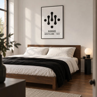 Bauhaus Art Black and White, framed on the wall of a minimalist adult bedroom in a modern UK flat with a white wall and walnut floor