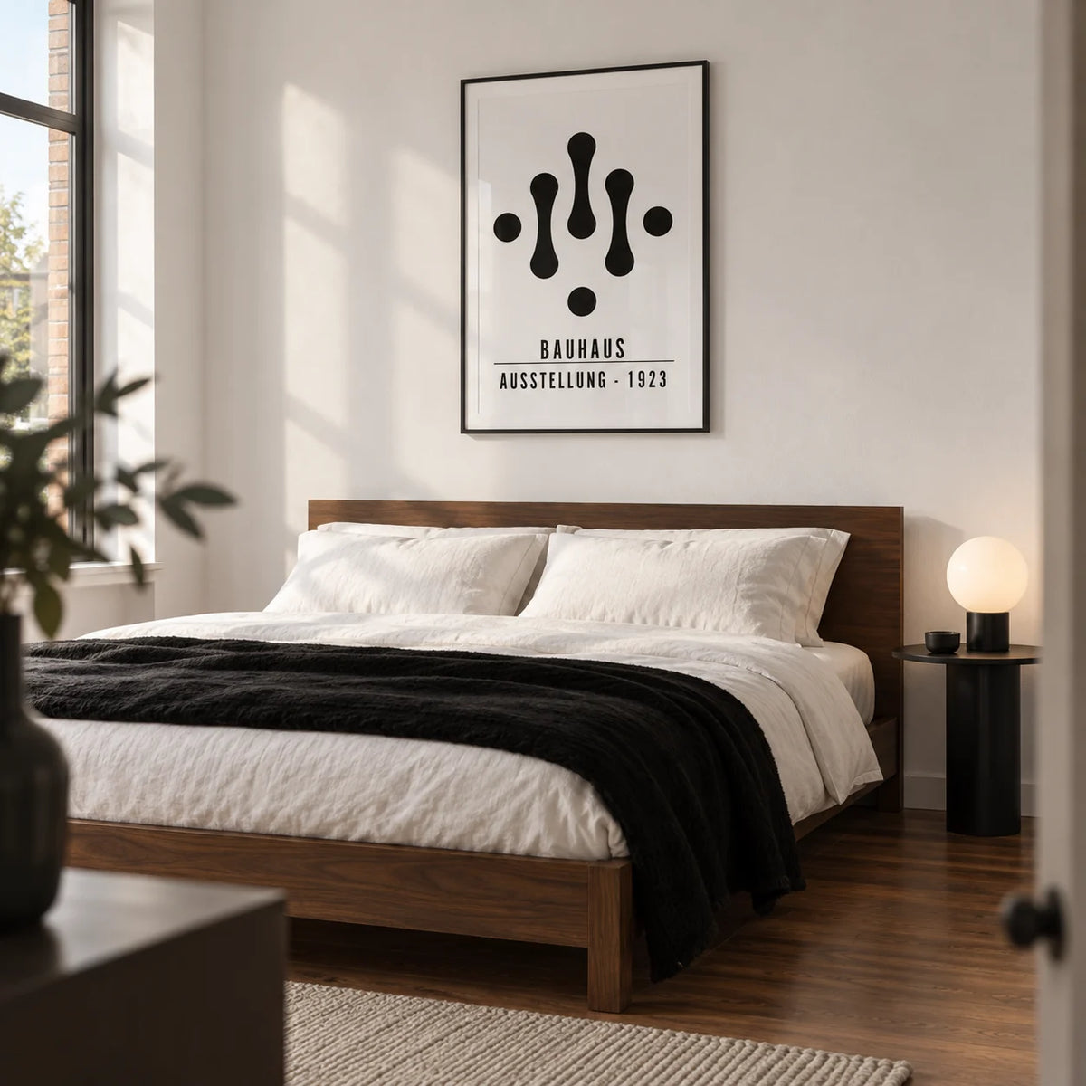 Bauhaus Art Black and White, framed on the wall of a minimalist adult bedroom in a modern UK flat with a white wall and walnut floor
