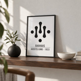 Bauhaus Art Black and White, a small A4 framed print leaning on a walnut shelf in a living room