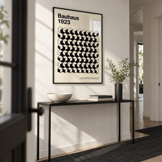 Bauhaus Design, framed on the wall of a crisp monochrome hallway with white walls and a black floor runner
