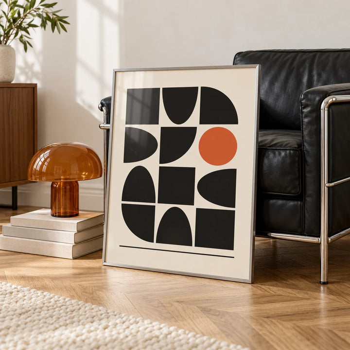 Bauhaus Geometric Shapes, framed on the wall of a white room corner with soft daylight and herringbone oak parquet in a living room