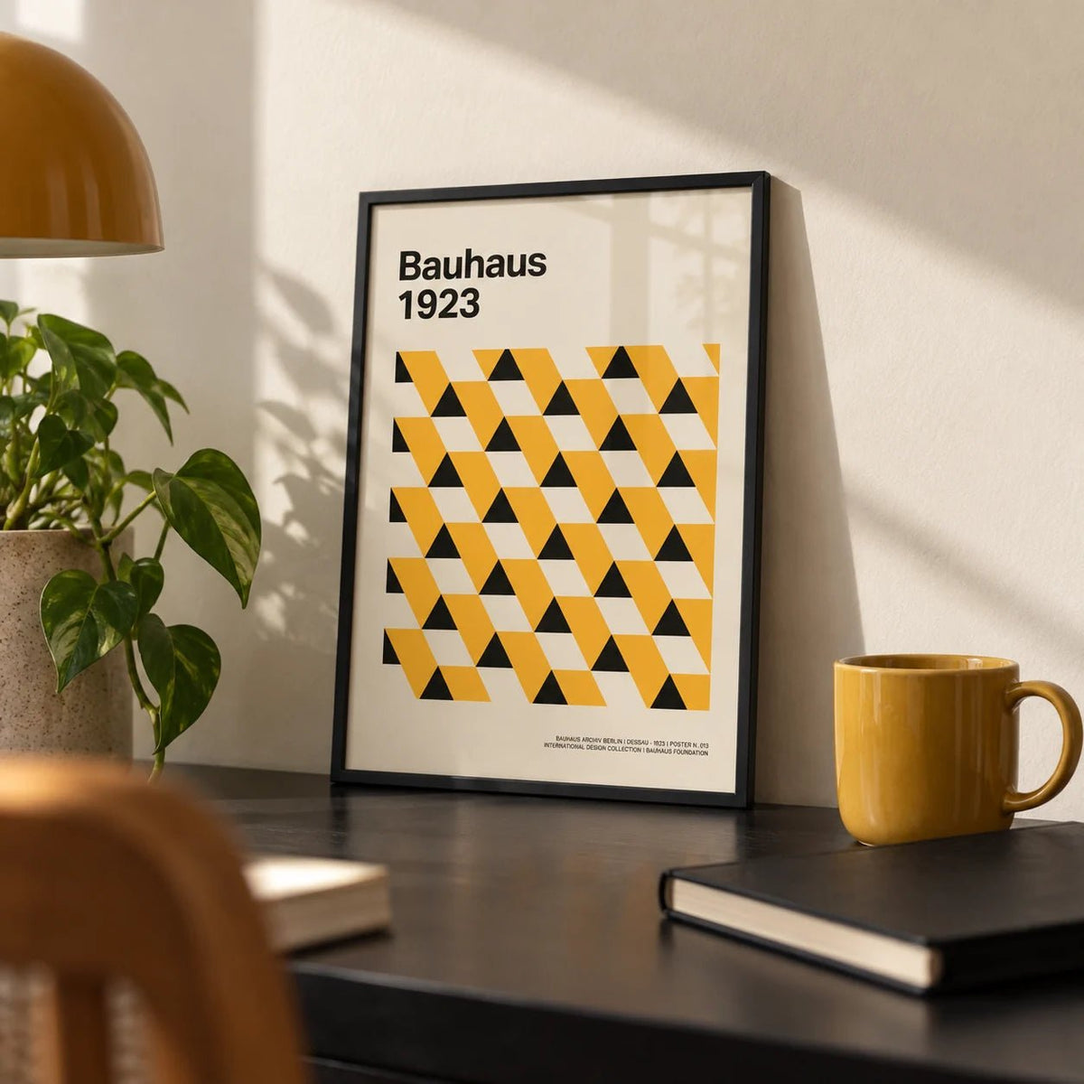 Bauhaus Poster 1923, a small A4 framed print leaning on a black desk