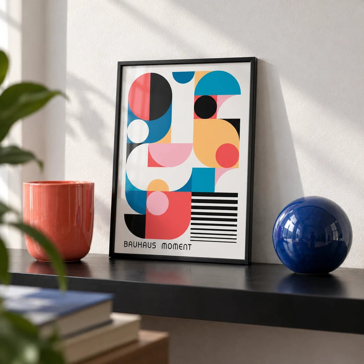 Bauhaus Poster Color, a small A4 framed print leaning on a black shelf in a living room