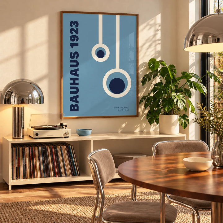 Bauhaus Posters, framed on the wall of a mid-century dining room with a round walnut table