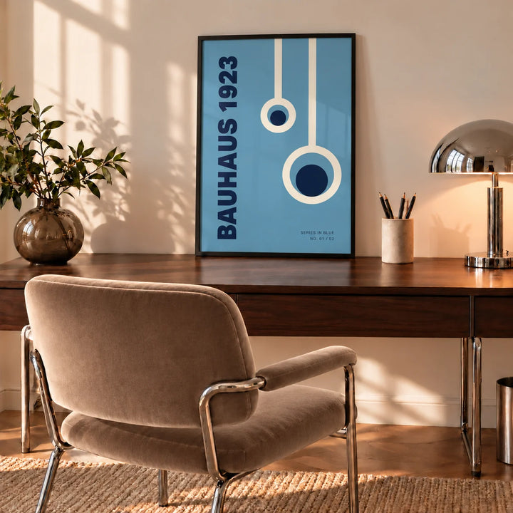 Bauhaus Posters, a framed print leaning on a walnut desk in a mid-century home office