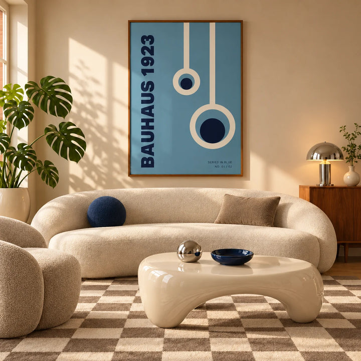 Bauhaus Posters, framed on the wall of a mid-century living room with a curved cream sofa