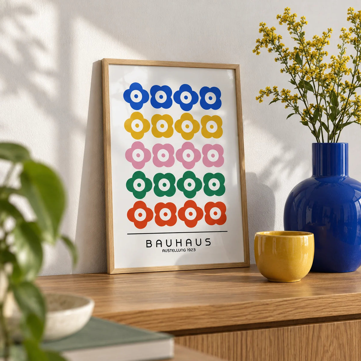 Bauhaus Print Design, a small A4 framed print leaning on an oak shelf in a living room