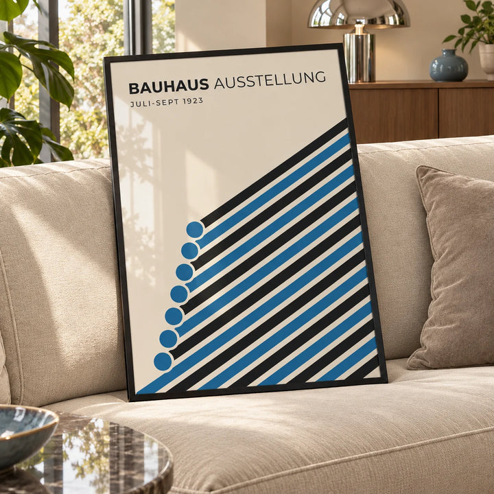 Bauhaus Print, a framed print leaning on a velvet sofa in a living room