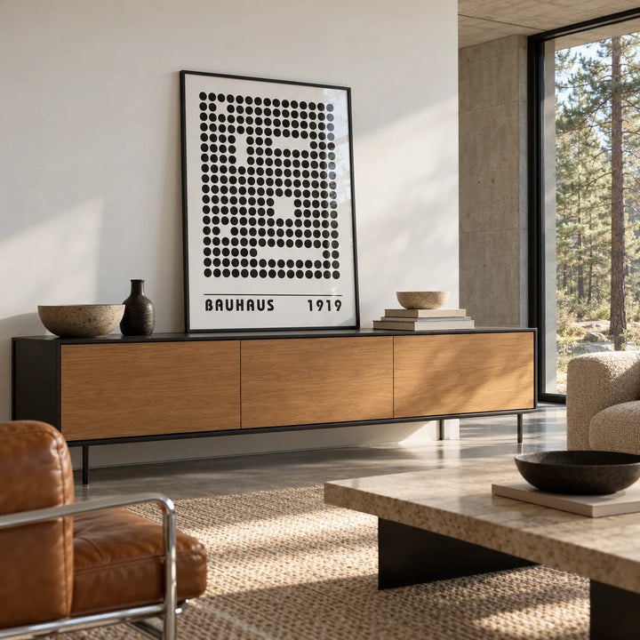 Bauhaus Prints, framed on the wall of a modernist concrete and glass living room with a floor-to-ceiling window onto pine trees