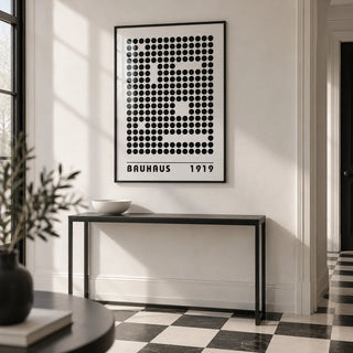 Bauhaus Prints, framed on the wall of a monochrome hallway with a white wall and a black and white floor
