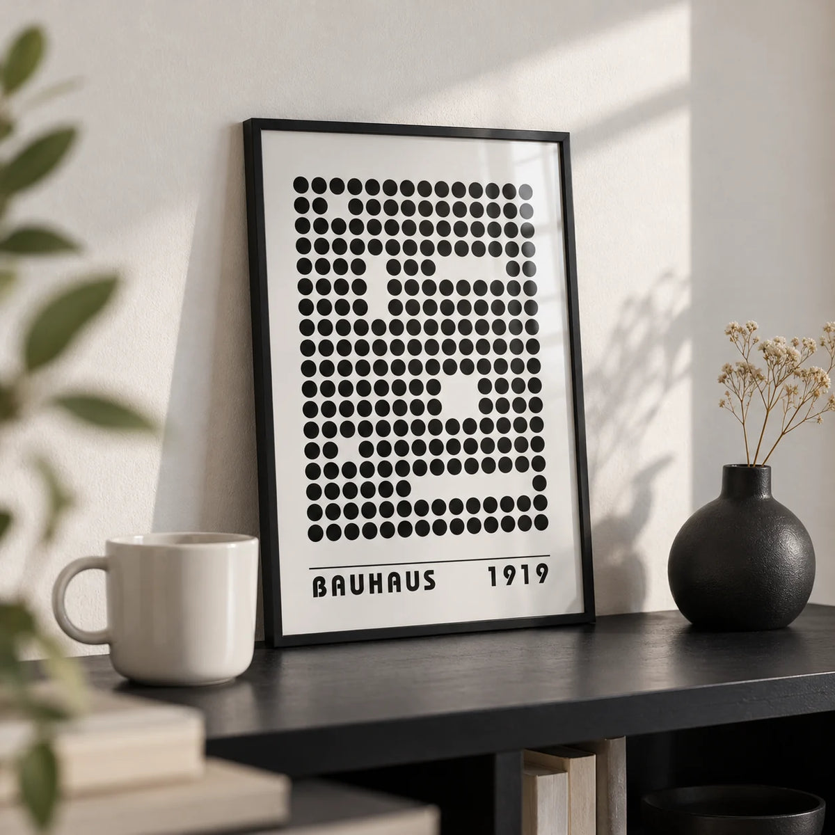 Bauhaus Prints, a small A4 framed print leaning on a black shelf in a living room
