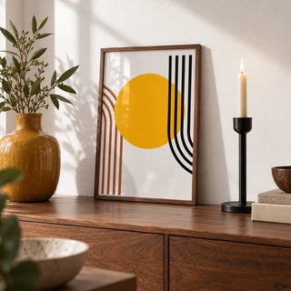 Bauhaus Sun Print, a small A4 framed print leaning on a walnut sideboard in a living room
